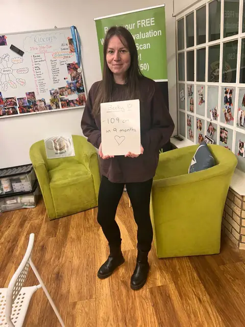 A club member holds up her assessment board at the club in Witney