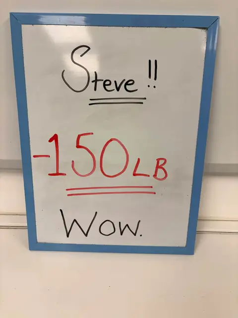 A member shows his assessment on a whiteboard, in the club room