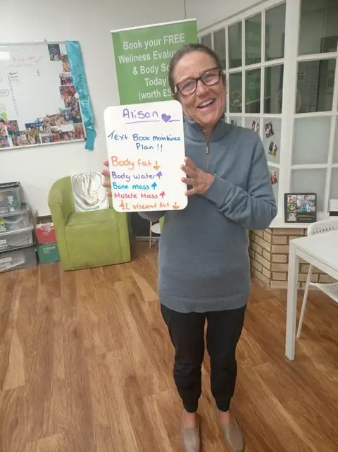 A club member holds up her assessment board at the club in Witney